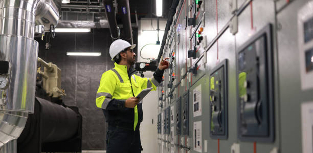Engineer working on industrial control panel
